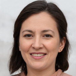 Joyful white adult female with medium  brown hair and brown eyes