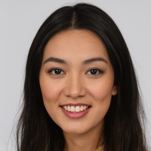 Joyful latino young-adult female with long  brown hair and brown eyes