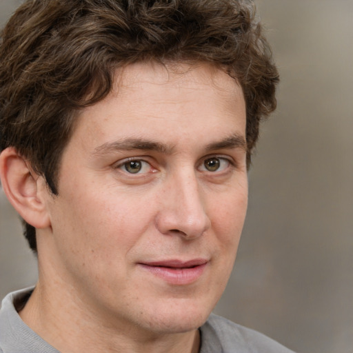 Joyful white adult male with short  brown hair and grey eyes