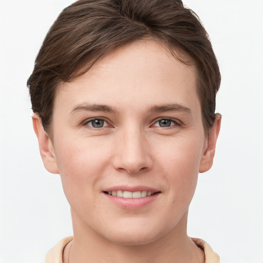 Joyful white young-adult female with short  brown hair and grey eyes