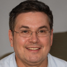 Joyful white adult male with short  brown hair and brown eyes