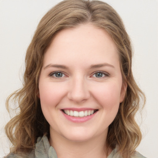 Joyful white young-adult female with medium  brown hair and green eyes