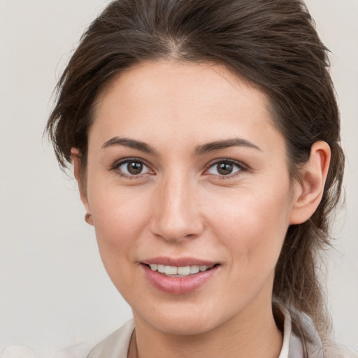 Joyful white young-adult female with medium  brown hair and brown eyes