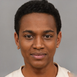 Joyful black young-adult male with short  black hair and brown eyes