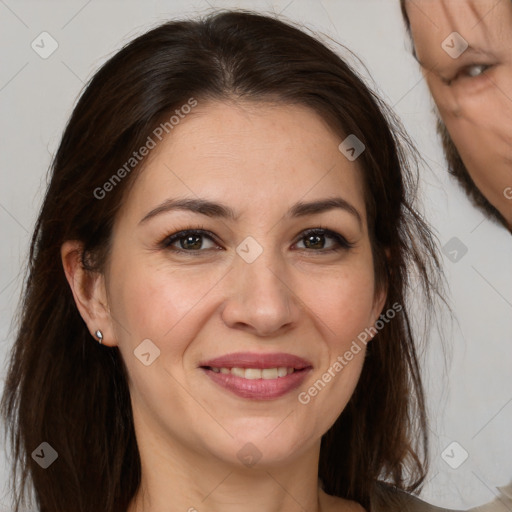 Joyful white adult female with long  brown hair and brown eyes