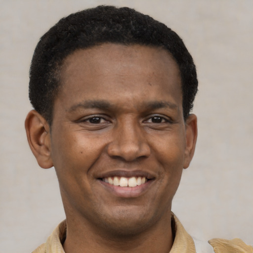 Joyful latino young-adult male with short  black hair and brown eyes