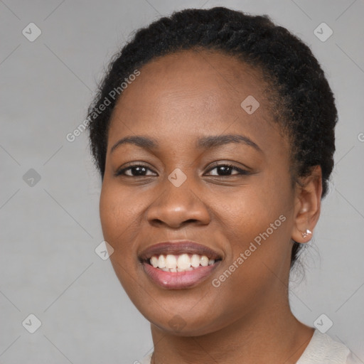 Joyful black young-adult female with short  brown hair and brown eyes