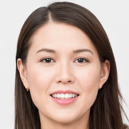 Joyful white young-adult female with long  brown hair and brown eyes