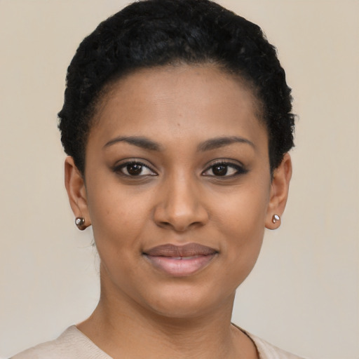 Joyful black young-adult female with short  black hair and brown eyes