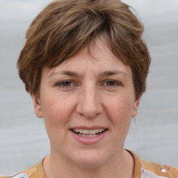 Joyful white adult female with short  brown hair and grey eyes