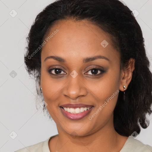 Joyful black young-adult female with long  brown hair and brown eyes