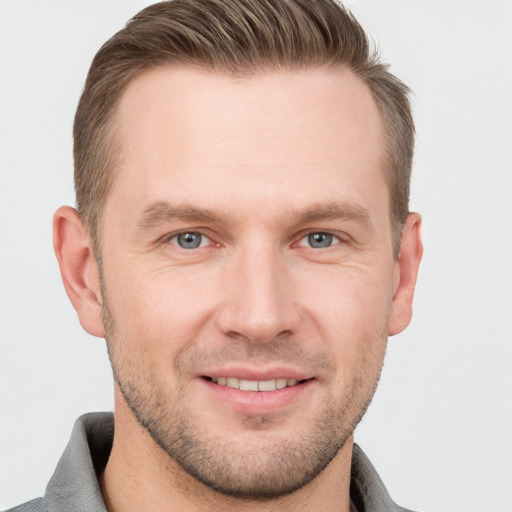 Joyful white adult male with short  brown hair and grey eyes