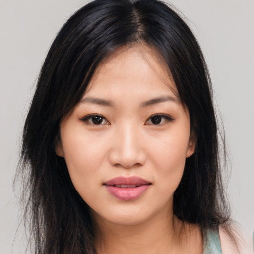 Joyful asian young-adult female with long  brown hair and brown eyes
