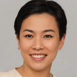 Joyful asian young-adult female with short  black hair and brown eyes