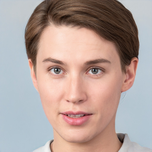 Joyful white young-adult female with short  brown hair and grey eyes