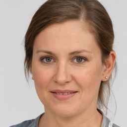 Joyful white adult female with medium  brown hair and brown eyes