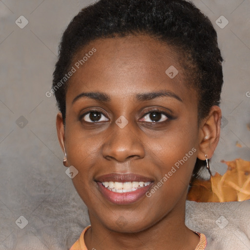 Joyful black young-adult female with short  brown hair and brown eyes