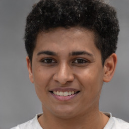 Joyful latino young-adult male with short  brown hair and brown eyes