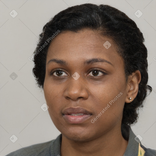 Joyful black young-adult female with short  black hair and brown eyes