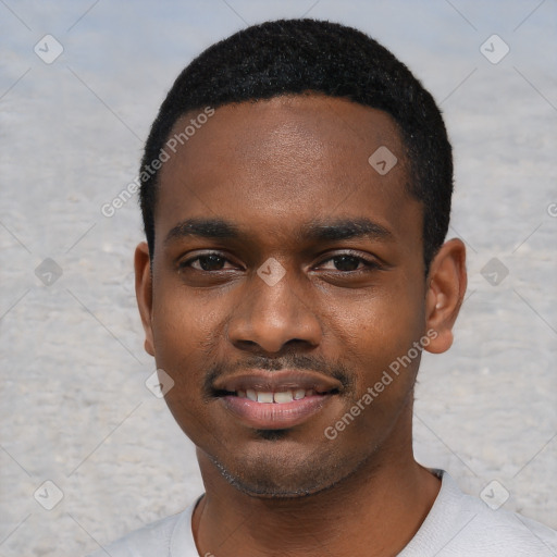 Joyful black young-adult male with short  black hair and brown eyes