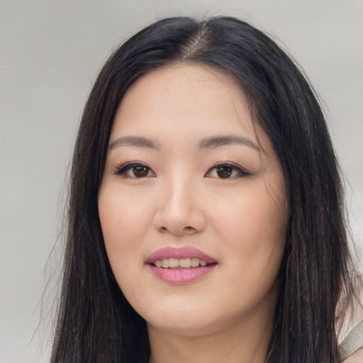 Joyful white young-adult female with long  black hair and brown eyes