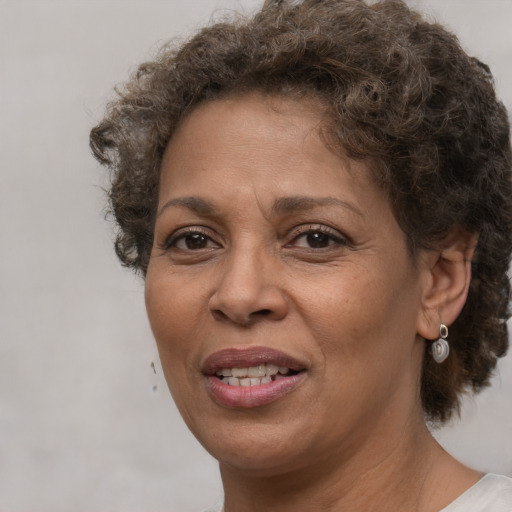 Joyful black adult female with short  brown hair and brown eyes