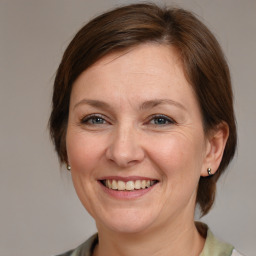 Joyful white adult female with medium  brown hair and brown eyes