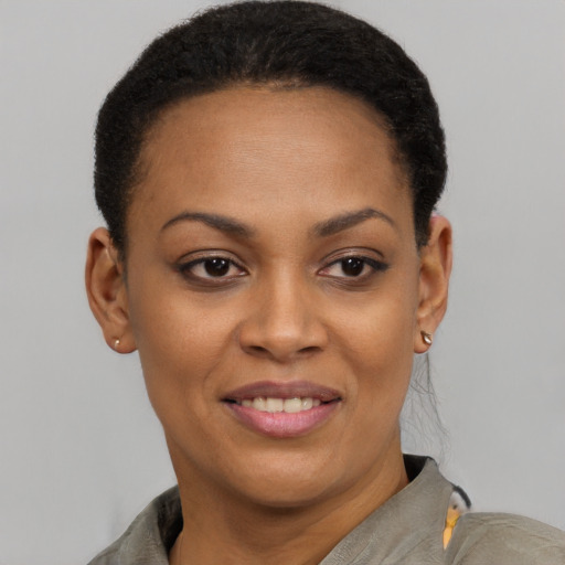 Joyful black young-adult female with short  brown hair and brown eyes