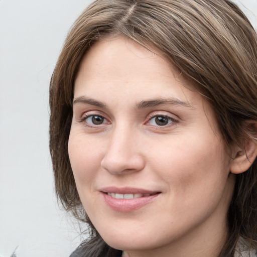 Joyful white young-adult female with medium  brown hair and grey eyes