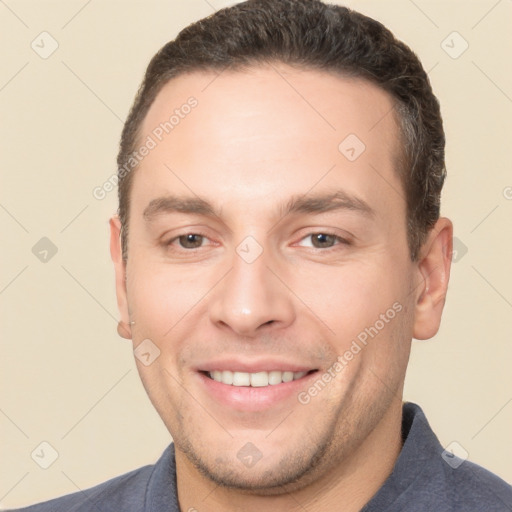 Joyful white adult male with short  brown hair and brown eyes