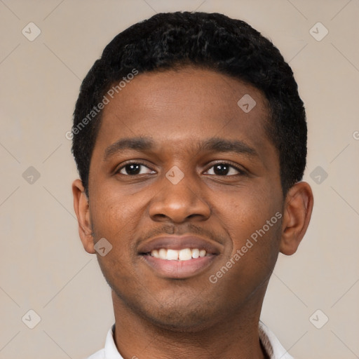 Joyful black young-adult male with short  black hair and brown eyes