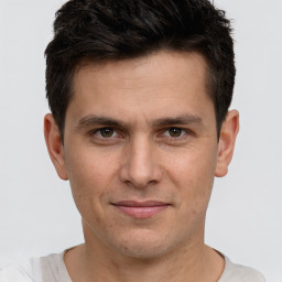 Joyful white adult male with short  brown hair and brown eyes