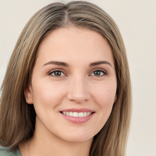 Joyful white young-adult female with long  brown hair and green eyes