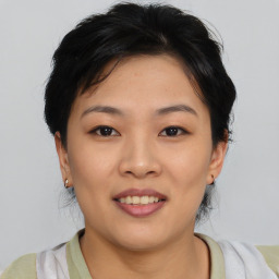 Joyful asian young-adult female with short  brown hair and brown eyes