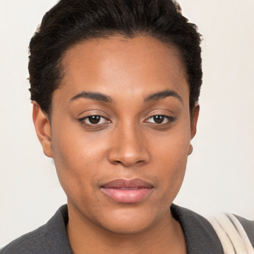 Joyful black young-adult female with short  brown hair and brown eyes