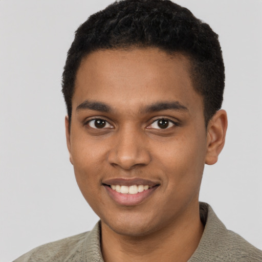 Joyful black young-adult male with short  black hair and brown eyes