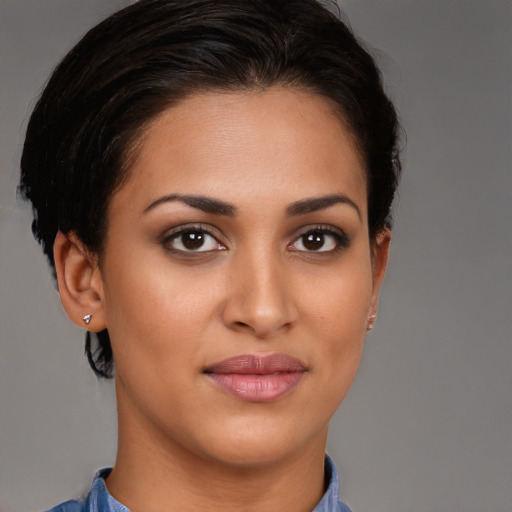 Joyful latino young-adult female with short  brown hair and brown eyes