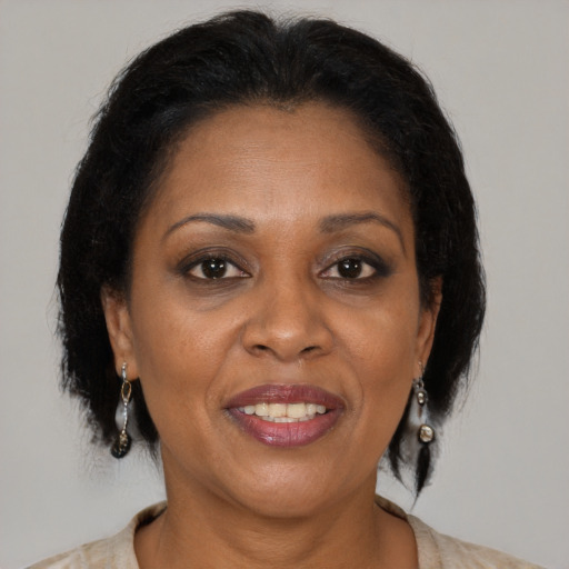 Joyful black adult female with medium  brown hair and brown eyes