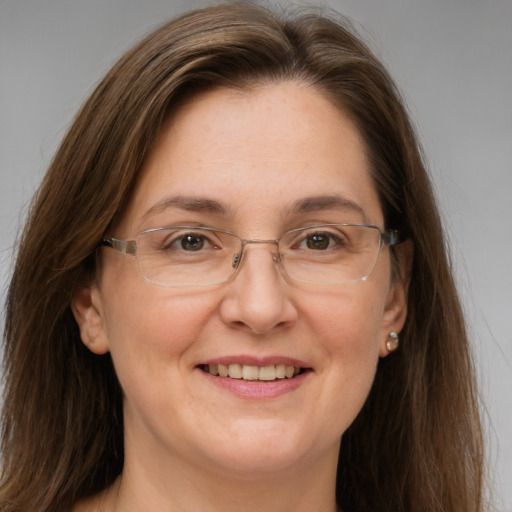 Joyful white adult female with long  brown hair and grey eyes