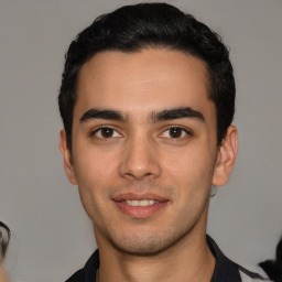 Joyful white young-adult male with short  black hair and brown eyes