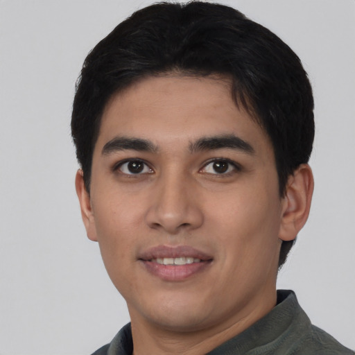 Joyful asian young-adult male with short  black hair and brown eyes