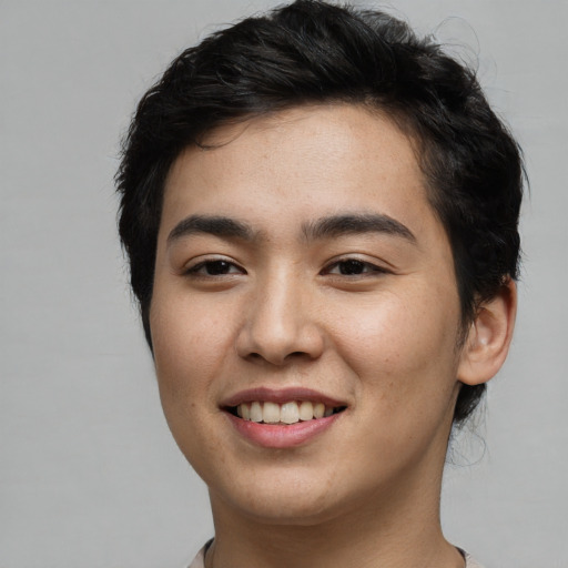 Joyful asian young-adult male with short  brown hair and brown eyes
