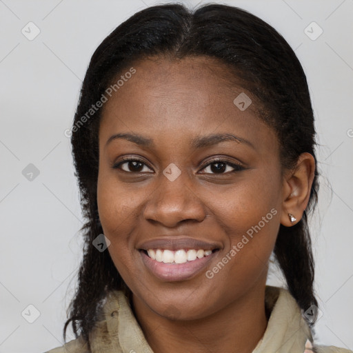 Joyful black young-adult female with long  brown hair and brown eyes