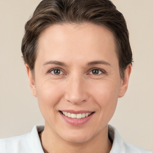 Joyful white young-adult female with short  brown hair and brown eyes