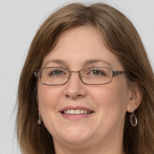 Joyful white adult female with long  brown hair and grey eyes