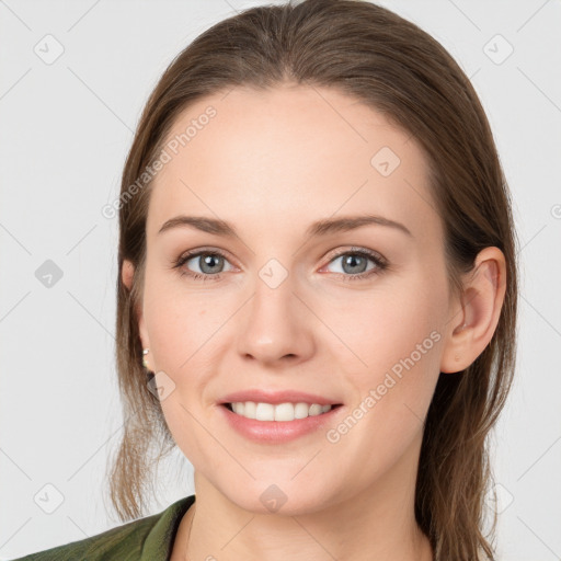 Joyful white young-adult female with long  brown hair and grey eyes