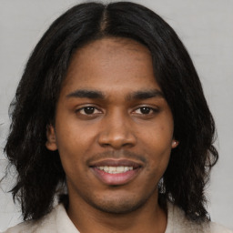 Joyful black young-adult male with medium  black hair and brown eyes