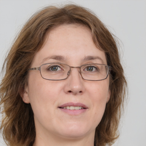 Joyful white adult female with medium  brown hair and green eyes