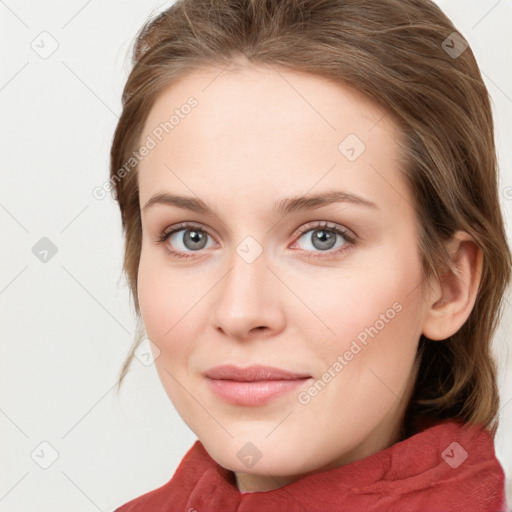 Joyful white young-adult female with medium  brown hair and blue eyes