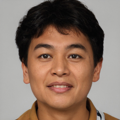 Joyful asian young-adult male with short  brown hair and brown eyes